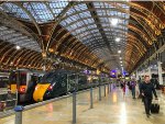 Passengers stream off a train at Paddington Station 